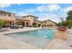 A luxurious backyard features a sparkling pool with fountains and a spacious, tiled patio area at 5203 N 179Th Dr, Litchfield Park, AZ 85340