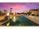 Gorgeous pool featuring elegant fire features, desert landscaping, and a peaceful outdoor space at 5203 N 179Th Dr, Litchfield Park, AZ 85340