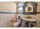 Charming powder room with unique sink and decorative mirror at 5203 N 179Th Dr, Litchfield Park, AZ 85340