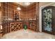 Spacious wine cellar featuring wooden racks, storage space and an ornate iron door, perfect for wine enthusiasts at 5203 N 179Th Dr, Litchfield Park, AZ 85340