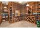 Custom wine cellar with wooden racks, storage and lighting designed to showcase an extensive wine collection at 5203 N 179Th Dr, Litchfield Park, AZ 85340