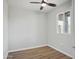 Empty bedroom featuring wood look flooring, a ceiling fan, a window, and neutral-colored walls at 533 N Sirrine --, Mesa, AZ 85201