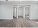Neutral living area with wood-look floors and multiple doorways, creating an open layout at 533 N Sirrine --, Mesa, AZ 85201