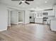 Open-concept living room and kitchen featuring stainless steel appliances and wood-look floors at 533 N Sirrine --, Mesa, AZ 85201