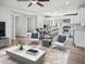Bright living space with wood floors, ceiling fan, dining area, and open access to the kitchen at 533 N Sirrine --, Mesa, AZ 85201