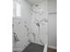 Updated shower with sleek, modern fixtures and black and white mosaic tile flooring at 533 N Sirrine --, Mesa, AZ 85201