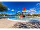 Spacious community pool with colorful water slides and play area under a clear blue sky at 6473 W Victory Way, Florence, AZ 85132