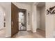 Bright foyer with tile flooring, security screen door, and neutral paint at 6473 W Victory Way, Florence, AZ 85132