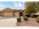 Charming single-story home with a xeriscaped yard, mature tree, and a two-car garage at 6473 W Victory Way, Florence, AZ 85132