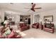 Open concept living area with tile floors flows into the kitchen and dining space at 6473 W Victory Way, Florence, AZ 85132