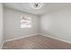 Cozy bedroom with light-toned laminate flooring and natural light from a large window at 702 N Evergreen St, Gilbert, AZ 85233