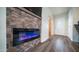 Modern fireplace with decorative stone and flat screen TV in a well-lit room at 712 Felspar Dr, Apache Junction, AZ 85119