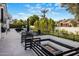 A luxury backyard with a fire pit, lounge area, and manicured lawn at 7120 E Paradise Ranch Rd, Paradise Valley, AZ 85253