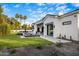 Exterior showcasing a modern patio, a pool, a manicured lawn, and palm trees at 7120 E Paradise Ranch Rd, Paradise Valley, AZ 85253
