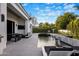 A luxury backyard with a pool, lounge area, and elegant outdoor dining at 7120 E Paradise Ranch Rd, Paradise Valley, AZ 85253