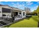 A covered patio overlooking the pool, manicured lawn, and mountain views at 7120 E Paradise Ranch Rd, Paradise Valley, AZ 85253