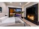 Bedroom featuring a fireplace, view of the pool, and modern fixtures at 7120 E Paradise Ranch Rd, Paradise Valley, AZ 85253