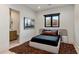 Modern bedroom featuring neutral tones, an area rug, and a bright window view at 7120 E Paradise Ranch Rd, Paradise Valley, AZ 85253