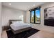 Bright bedroom with white walls and hardwood floors and plush rug at 7120 E Paradise Ranch Rd, Paradise Valley, AZ 85253