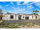 Beautiful single-story home with a modern design, dark framed windows and desert landscaping at 7120 E Paradise Ranch Rd, Paradise Valley, AZ 85253