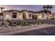 Attractive exterior showcasing desert landscaping, a glass garage door and a paved driveway at 7120 E Paradise Ranch Rd, Paradise Valley, AZ 85253