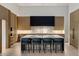 Modern kitchen featuring sleek cabinets, marble countertops, and seating for four at 7120 E Paradise Ranch Rd, Paradise Valley, AZ 85253