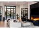Bright living room featuring hardwood floors, a fireplace, and views of the front yard at 7120 E Paradise Ranch Rd, Paradise Valley, AZ 85253
