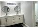 Bright bathroom featuring a double sink vanity with modern fixtures and stylish round mirrors at 718 W Paseo Way, Tempe, AZ 85283