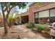 Relax in your private backyard oasis with a covered patio, lush trees, and stone pavers at 7445 E Eagle Crest Dr # 1094, Mesa, AZ 85207