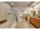 Bright bathroom with a tub, glass-enclosed shower, double vanity, and tile flooring at 7445 E Eagle Crest Dr # 1094, Mesa, AZ 85207