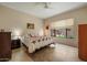 Tranquil bedroom with a patterned quilt, natural light, and a view of the outdoor landscaping at 7445 E Eagle Crest Dr # 1094, Mesa, AZ 85207