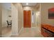 A view of the bright foyer featuring a wooden front door and tile floors at 7445 E Eagle Crest Dr # 1094, Mesa, AZ 85207