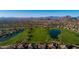 Aerial view of a beautifully maintained golf course with picturesque lakes and mountain views in a vibrant community at 7445 E Eagle Crest Dr # 1094, Mesa, AZ 85207