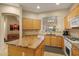Kitchen featuring granite countertops, wooden cabinets, and arched pass through to dining area at 7445 E Eagle Crest Dr # 1094, Mesa, AZ 85207