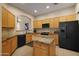 This kitchen boasts a central island, ample storage, and sleek black appliances at 7445 E Eagle Crest Dr # 1094, Mesa, AZ 85207