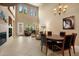 Spacious living room with fireplace, high ceilings, and a dining area with seating for four at 7445 E Eagle Crest Dr # 1094, Mesa, AZ 85207