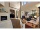 Cozy living room with a fireplace, comfortable seating, and large windows for natural light at 7445 E Eagle Crest Dr # 1094, Mesa, AZ 85207