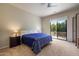 Comfortable main bedroom with a private balcony, soft carpet, and ample natural light at 7445 E Eagle Crest Dr # 1094, Mesa, AZ 85207