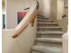 Elegant carpeted staircase with a curved wooden handrail and neutral-toned walls at 7445 E Eagle Crest Dr # 1094, Mesa, AZ 85207