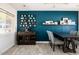 Dining room with dark blue accent wall and decorative display of coffee cups and books at 7506 E Granada Rd, Scottsdale, AZ 85257