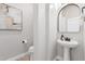 Elegant powder room featuring a modern pedestal sink, sleek fixtures, and neutral tones at 790 E San Carlos Way, Chandler, AZ 85249