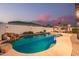 A beautiful backyard pool features rock accents, nearby gazebo and beautiful dusk sky at 790 E San Carlos Way, Chandler, AZ 85249