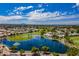 Picturesque aerial view of the community with a serene lake, golf course, and beautifully landscaped grounds at 8312 E Pueblo Ave, Mesa, AZ 85208