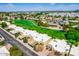 Aerial view of the community golf course and surrounding homes showcasing lush landscaping at 8312 E Pueblo Ave, Mesa, AZ 85208