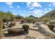 This backyard features a unique rock drainage system and desert landscaping at 9515 E Julep Cir, Mesa, AZ 85207