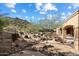 This backyard showcases desert landscaping, a rock drainage system, and mountain views at 9515 E Julep Cir, Mesa, AZ 85207