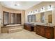 Bathroom features a soaking tub, dual vanities, and shuttered windows at 9515 E Julep Cir, Mesa, AZ 85207