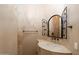 Bathroom featuring a stone countertop vanity with decorative framed mirror and a tile backsplash at 9515 E Julep Cir, Mesa, AZ 85207