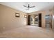 Spacious bedroom with sliding glass doors to the patio, ceiling fan, and shuttered windows at 9515 E Julep Cir, Mesa, AZ 85207