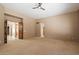 Spacious bedroom with a ceiling fan and wood doors to other rooms at 9515 E Julep Cir, Mesa, AZ 85207